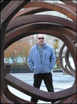 Image of DMH looking through a twisted metal public sculpture on Michigan Ave in Chicago.